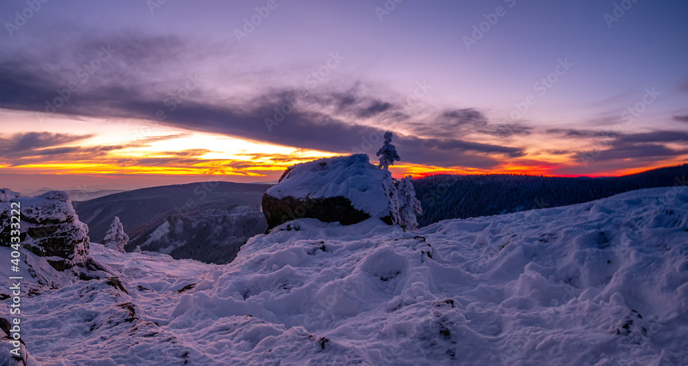 Harsh landscape on a mountain range of Jeseniky mountains, rock, clouds, sun, snow. Czech Republic.  .