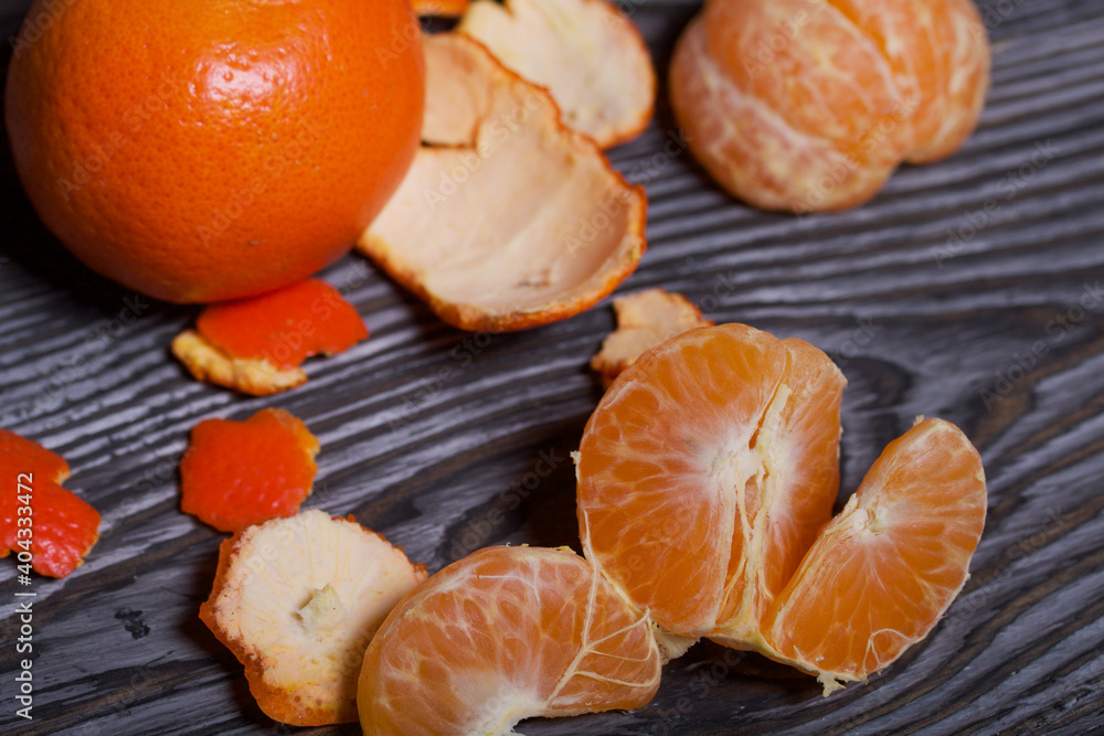 Orange tangerines. One of them is peeled. Close-up shot. Orange tangerines. One of them is peeled. Close-up shot.
