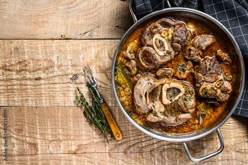 Stewed veal shank meat Osso Buco, italian ossobuco steak. wooden background. Top view. Copy space