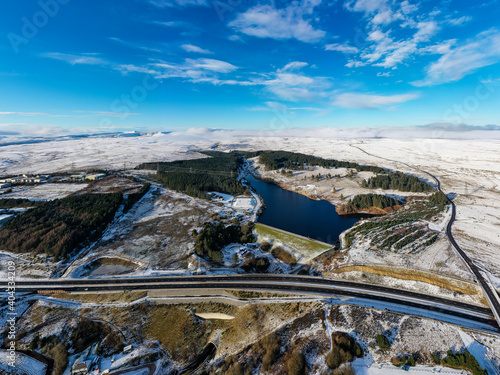 Aerial view of a major road running through a snowy landscape