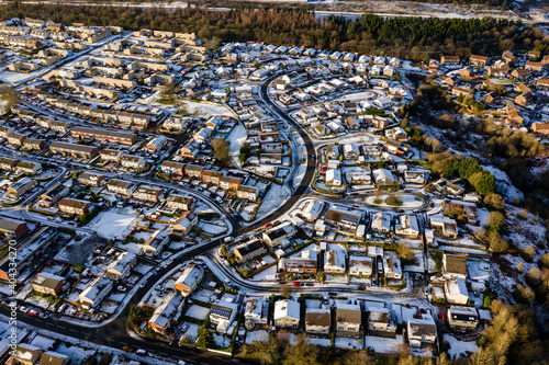Aerial view of snow covered houses and streets in a small town