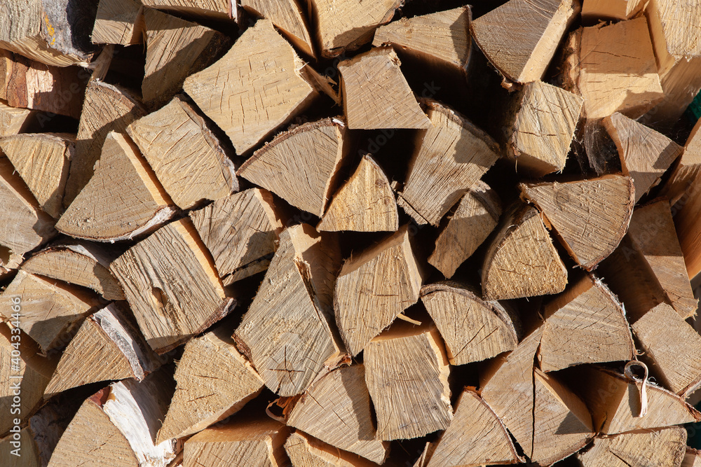 Background from stack of firewood from birch tree, for heating house, stacked in backyard, uncut wood, birch. Concept eco-friendly home heating during cold season. Overall plan. Horizontal format Background from stack of firewood from birch tree, for heating house, stacked in backyard, uncut wood, birch. Concept eco-friendly home heating during cold season. Overall plan. Horizontal format