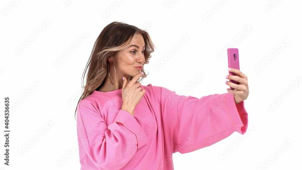 Funny trendy woman posing taking selfie use smartphone isolated. Shot on RED Raven 4k Cinema Camera Funny trendy woman posing taking selfie use smartphone isolated. Shot on RED Raven 4k Cinema Camera
