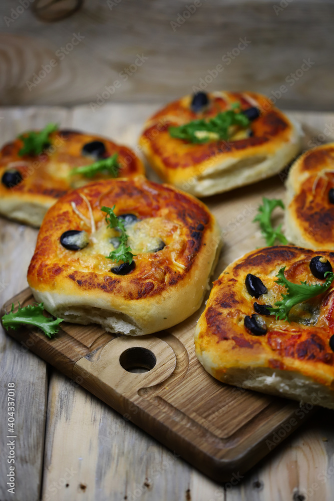 Soft focus. Homemade mini pizzas on a wooden board. Healthy food. Soft focus. Homemade mini pizzas on a wooden board. Healthy food.