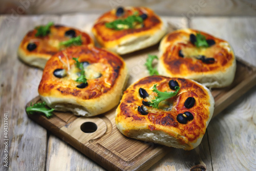 Soft focus. Homemade mini pizzas on a wooden board. Healthy food.