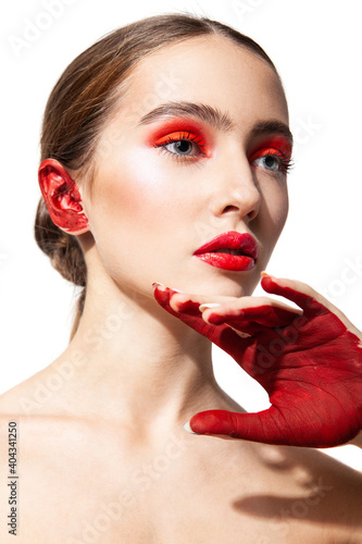 Woman with red makeup and painted hand