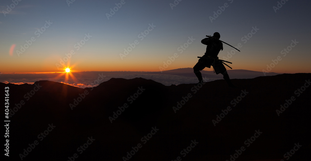 Silhouette of a Japanesesamurai with sword training during sunset