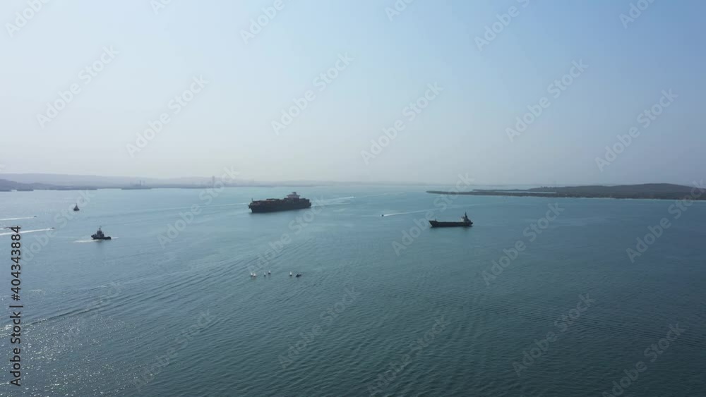Cargo ship enters to the port aerial view. Cargo ship enters to the port aerial view.