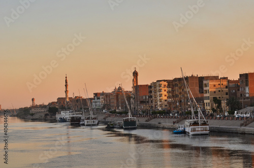 The coastline of Nile near City with Sail Boats in Egypt near Sunset
