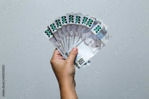 Hands holding Brazilian real notes photo
