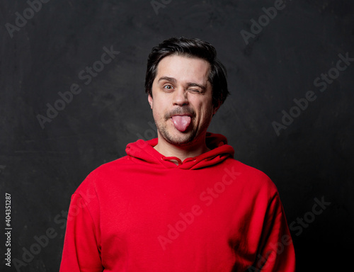 White fool guy in red sweatshirt on dark background