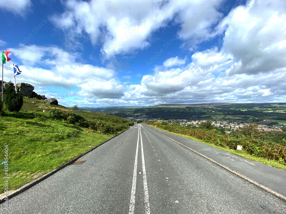 Looking down, Hangingstone Road, by the Cow and Calf Rock, with Ilkley and the Yorkshire Dales, in the distance Looking down, Hangingstone Road, by the Cow and Calf Rock, with Ilkley and the Yorkshire Dales, in the distance