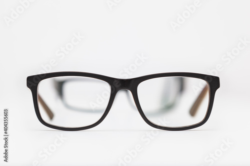 Two pairs of eyeglasses on a white background