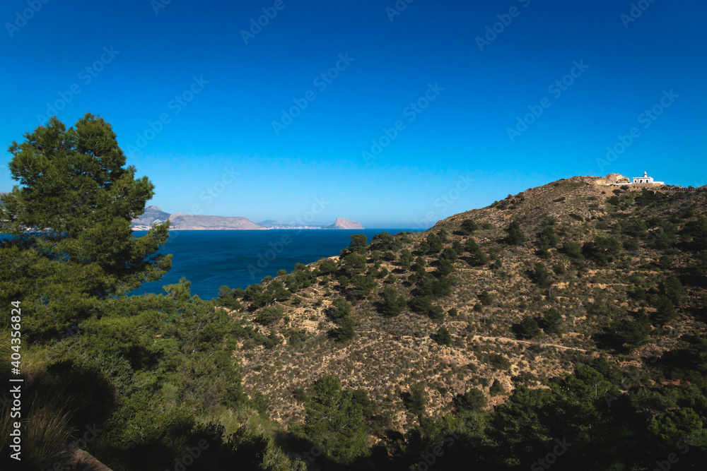 Panorama view of natural park 'Serra Gelada' with lighthouse and the Rock 'Ifach' of Calpe in the background, Albir, Costa Blanca, Spain