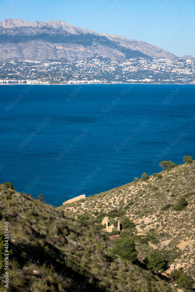 Natural park 'Serry Gelada' with view to Altea and ruin of ocher mine along the coast of Albir, Spain