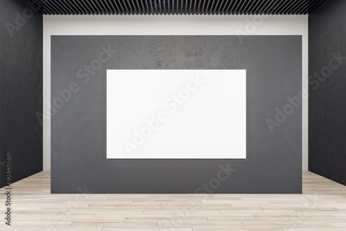 Modern exhibition interior with blank banner on concrete wall.