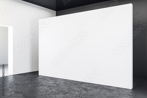 Spacious gallery interior with empty exhibition stand.