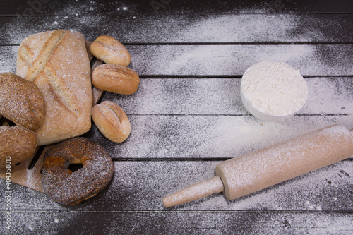 Homemade crusty bread cooking on blackboard background. Top view with space for your text