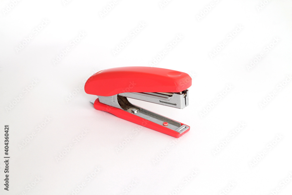 Red office stapler on an isolated white background Red office stapler on an isolated white background
