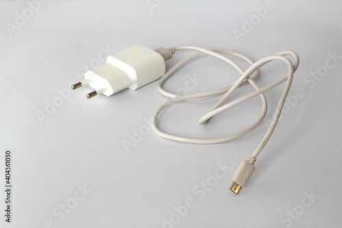 USB charge cable and power adapter on white background.