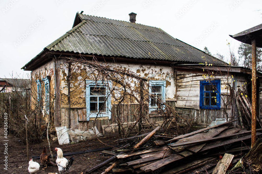 A very old house. Abandoned house, old courtyard. Vintage. Windows of an old house. Old yard with chickens. Background. A very old house. Abandoned house, old courtyard. Vintage. Windows of an old house. Old yard with chickens. Background.