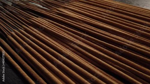 Group of brown incense sticks on dark background