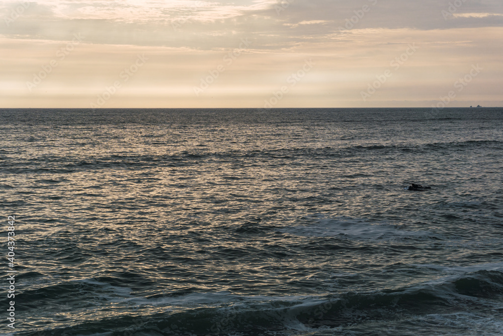 blue ocean panorama of Lima coast, sun reflexion and calm waves