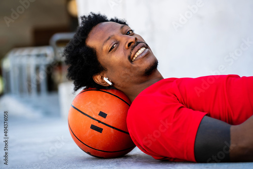 Afro athlete man laying on floor after training. © Mego-studio