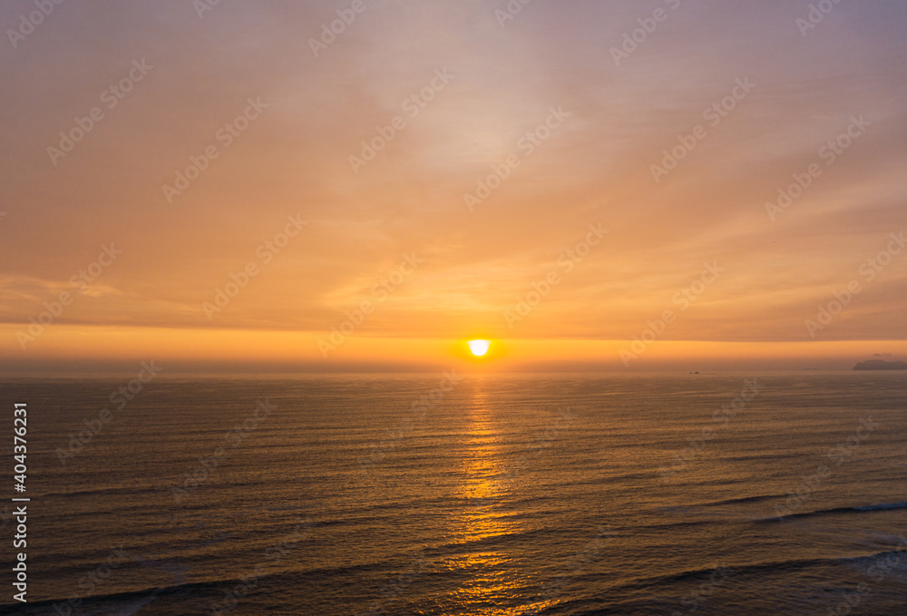 Beautiful sunset in Lima Peru, bright sky and underexposed beach, golden hour, orange sky