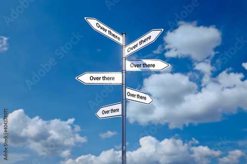 signpost with 6 arrow-shaped signs each with the words OVER THERE in different directions in front of a cloudy sky