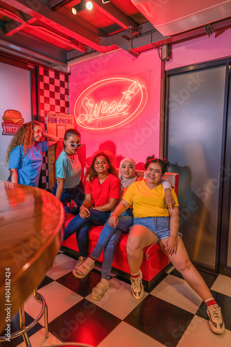 group of multiethnic women friends having fun get together in cafe