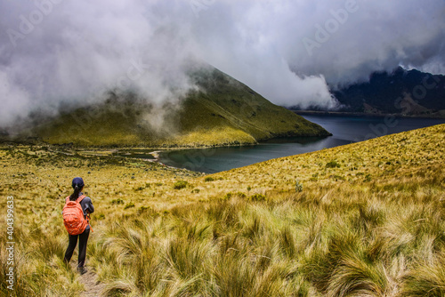 Trekker enjoying the view of the beautiful Lagunas de Mojanda from the Fuya Fuya trail, Otavalo, Ecuador photo