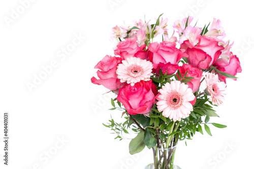 Bouquet of fresh pink gerberas, roses, and alstroemeria on a white background with copy space for congratulations text © Sergey + Marina