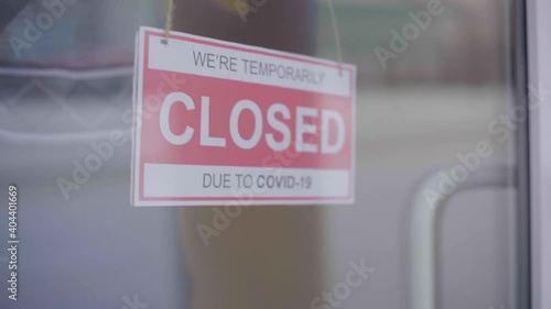Closed for business due to covid. Small shop puts closed sign up on storefront