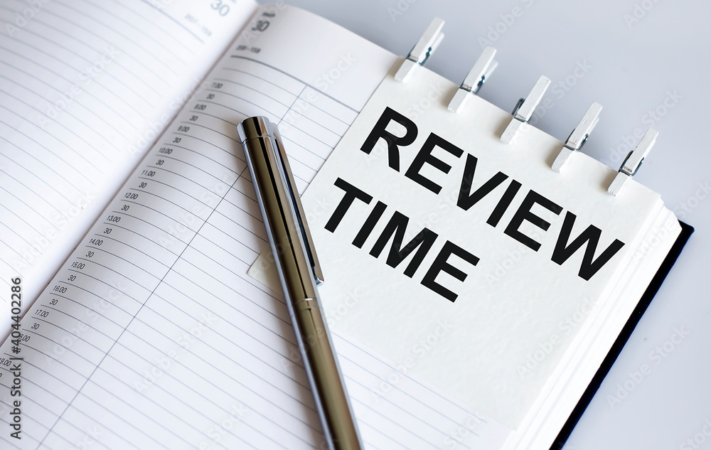 text REVIEW TIME on the short note texture background with pen text REVIEW TIME on the short note texture background with pen