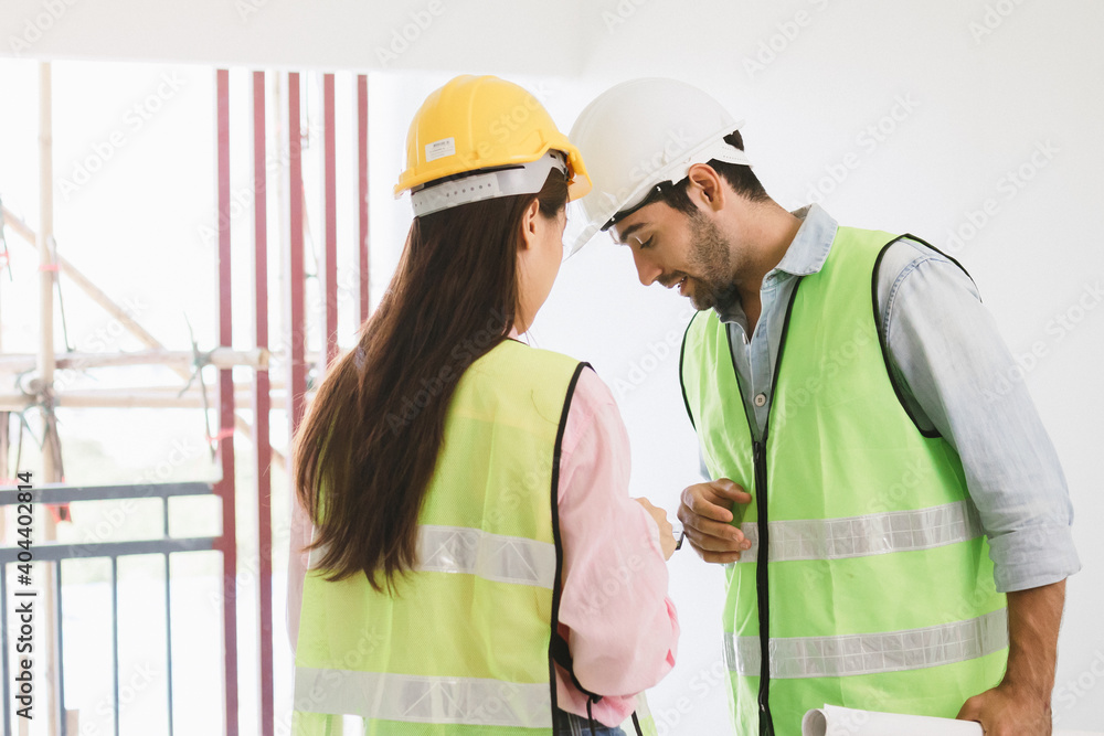 Team of young caucasian, asian man and woman contractor, partner explain and inspecting the reconstructed construction and renovated to check defect of apartment, home,house at job site, workplace.