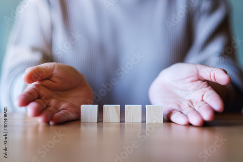 Closeup image of hands showing blank wooden cube blocks