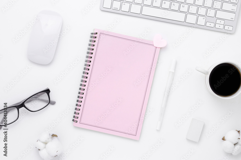Minimal Office desk table top view with pink notebook blank pages, Keyboard computer, mouse, coffee cup on a white table with copy space, White color workplace composition, flat lay Minimal Office desk table top view with pink notebook blank pages, Keyboard computer, mouse, coffee cup on a white table with copy space, White color workplace composition, flat lay