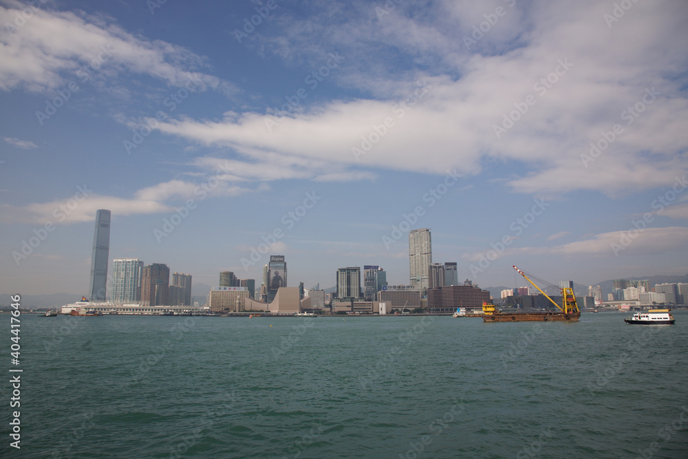 View of Victoria Harbor Skyline under blue sky in Hong Kong View of Victoria Harbor Skyline under blue sky in Hong Kong