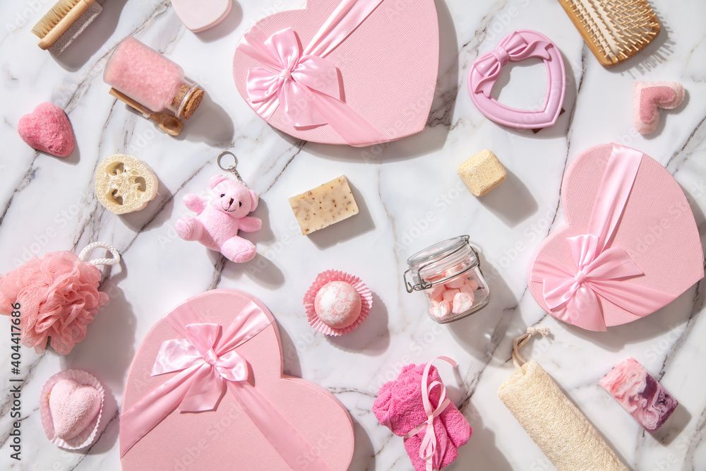 Top view of pink colored heart shaped gift boxes with homemade bath supplies, marshmallow sweets Top view of pink colored heart shaped gift boxes with homemade bath supplies, marshmallow sweets