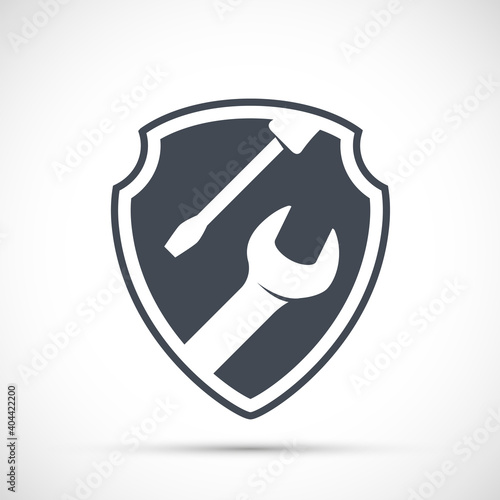 Tools wrench and screwdriver on shield. Vector icon.