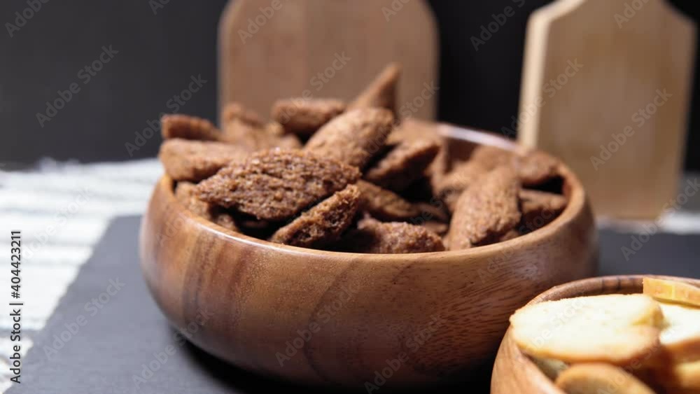 brown croutons in bowl. croutons in a brown bowl on a wooden table. Close-up. Selective focus. brown croutons in bowl. croutons in a brown bowl on a wooden table. Close-up. Selective focus.