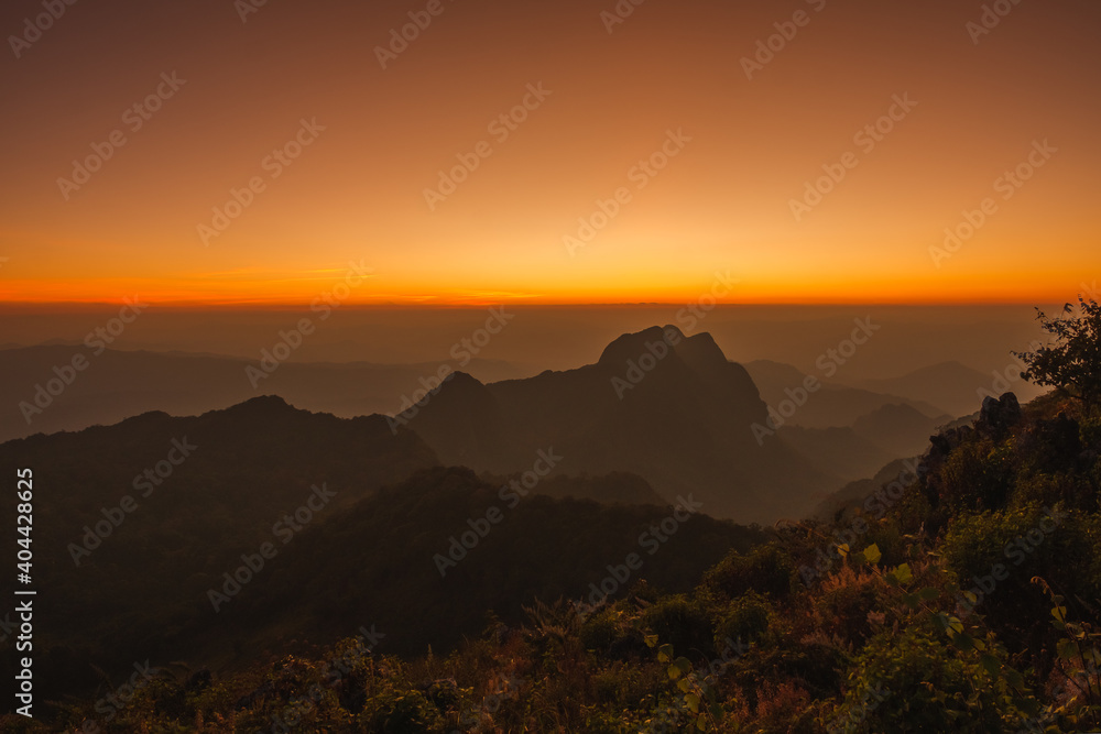 Mountains under mist in the Evening Setting sun beautiful Mountains from Doi Luang Chiang Dao Chiang Mai In Thailand Natural forest