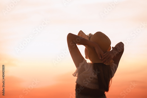 Silhouette of a healthy woman raising her hand on a blurred background