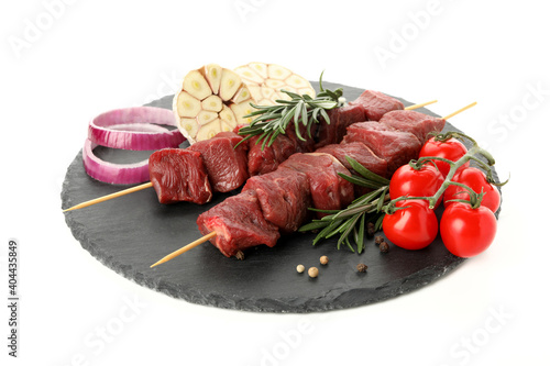 Fotografía Board with raw shish kebab meat and vegetables isolated on white background