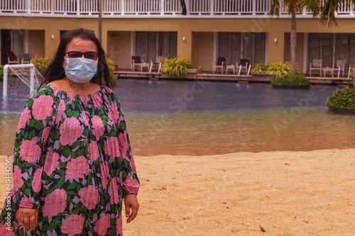 People hang out after COVID 19 outbreak,people wearing medical mask at beach, new normal rules,  Life after pandemic. photo