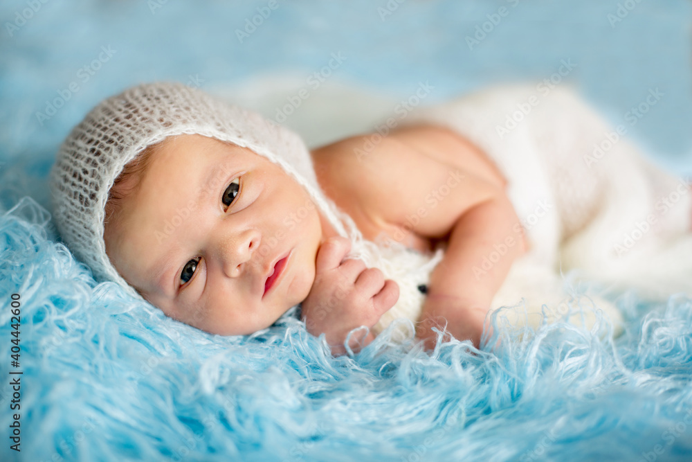 Little cute newborn baby boy, sleeping wrapped in white wrap Little cute newborn baby boy, sleeping wrapped in white wrap