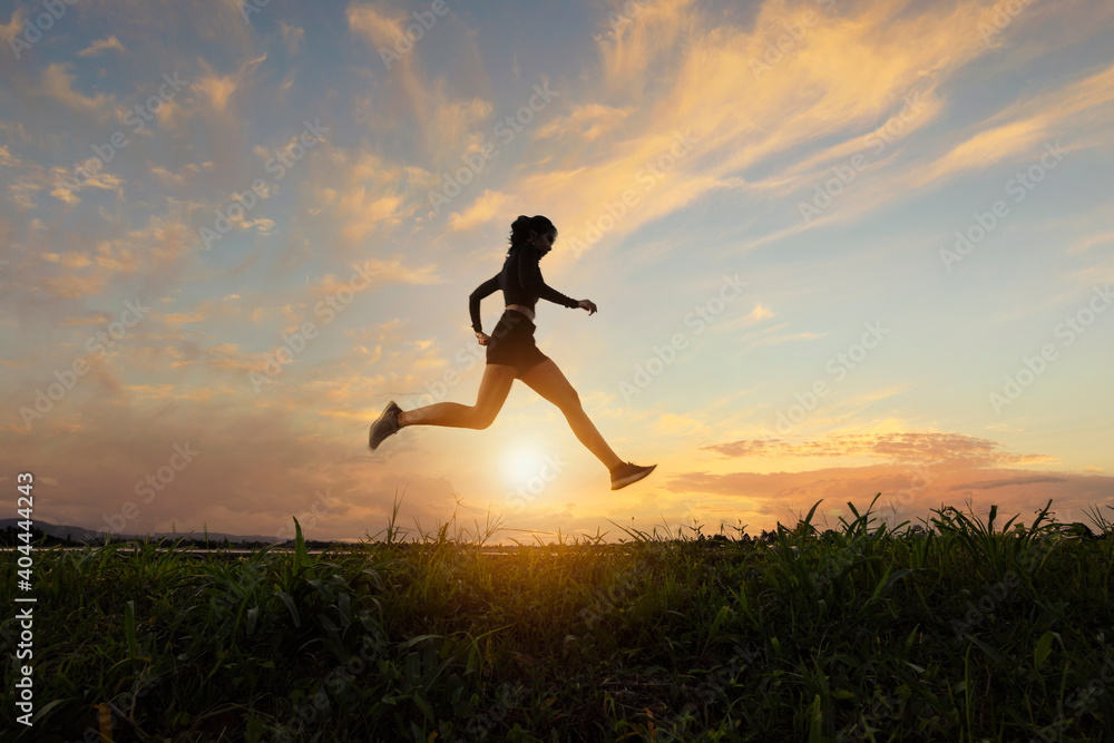 A beautiful sporty woman runing on the shore of a lake in sports.Sporty young woman running on road in beautiful nature. A beautiful sporty woman runing on the shore of a lake in sports.Sporty young woman running on road in beautiful nature.
