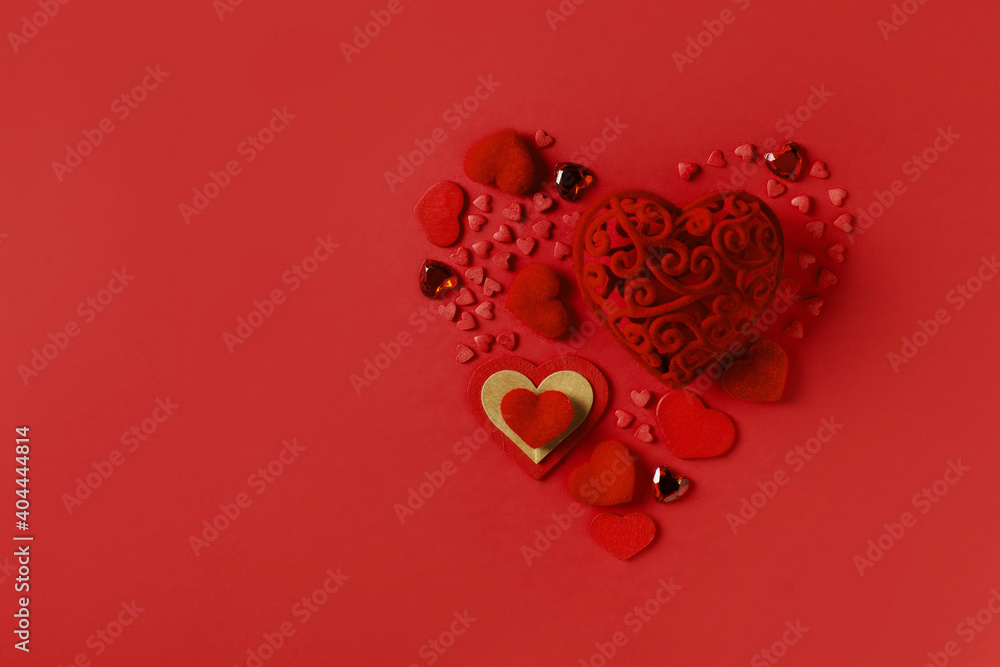Red valentine card with few hearts on red background