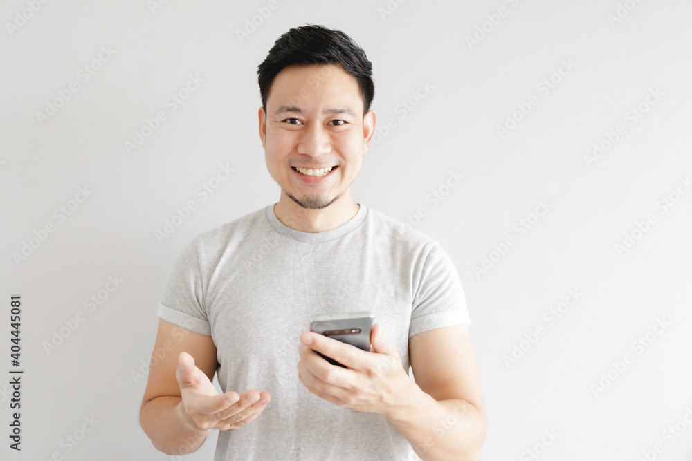 Asian man is feeling happy with the application in the smartphone. Asian man is feeling happy with the application in the smartphone.